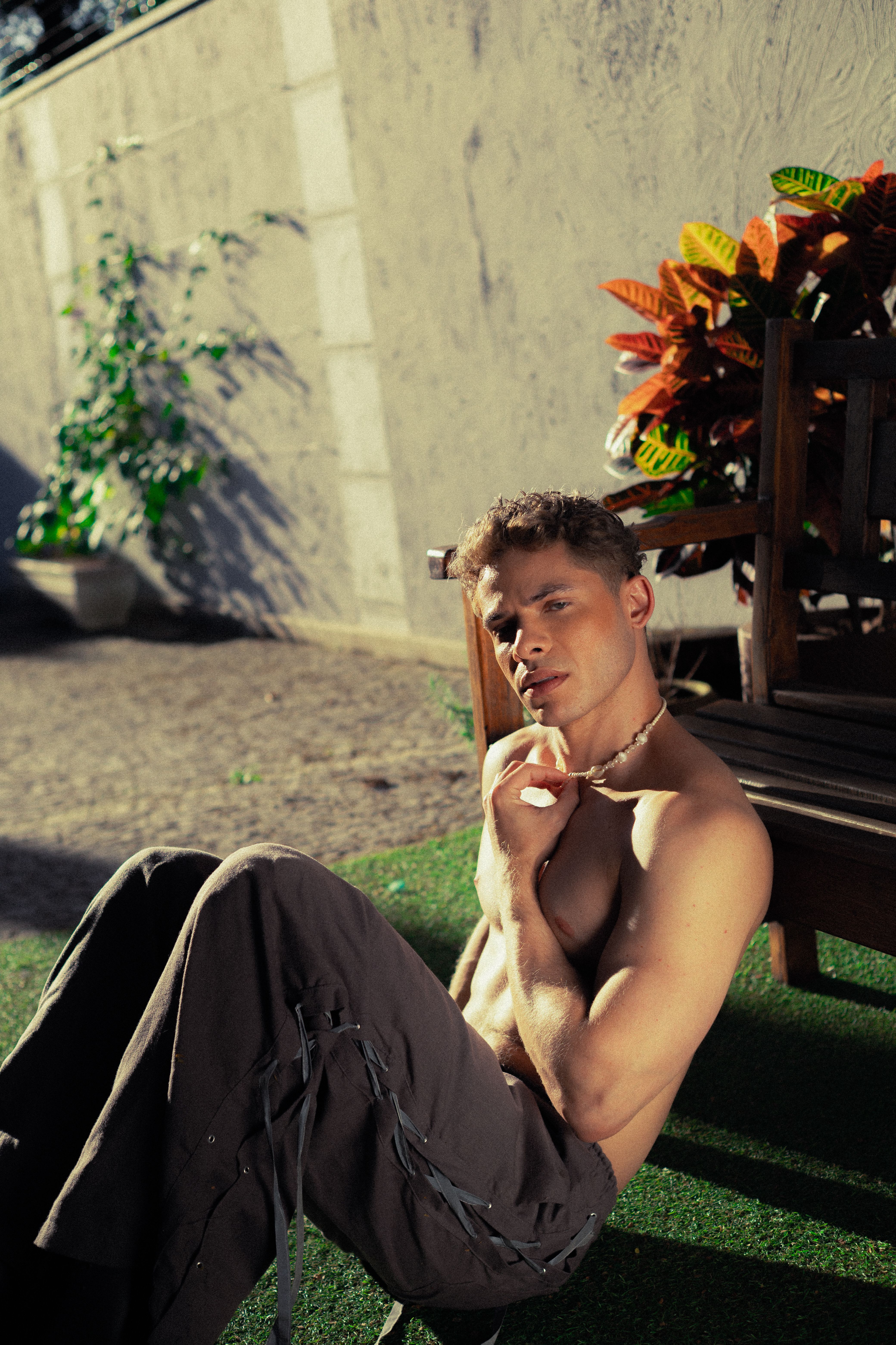 A young man sitting outdoors on a sunny day in São Paulo, Brasil.