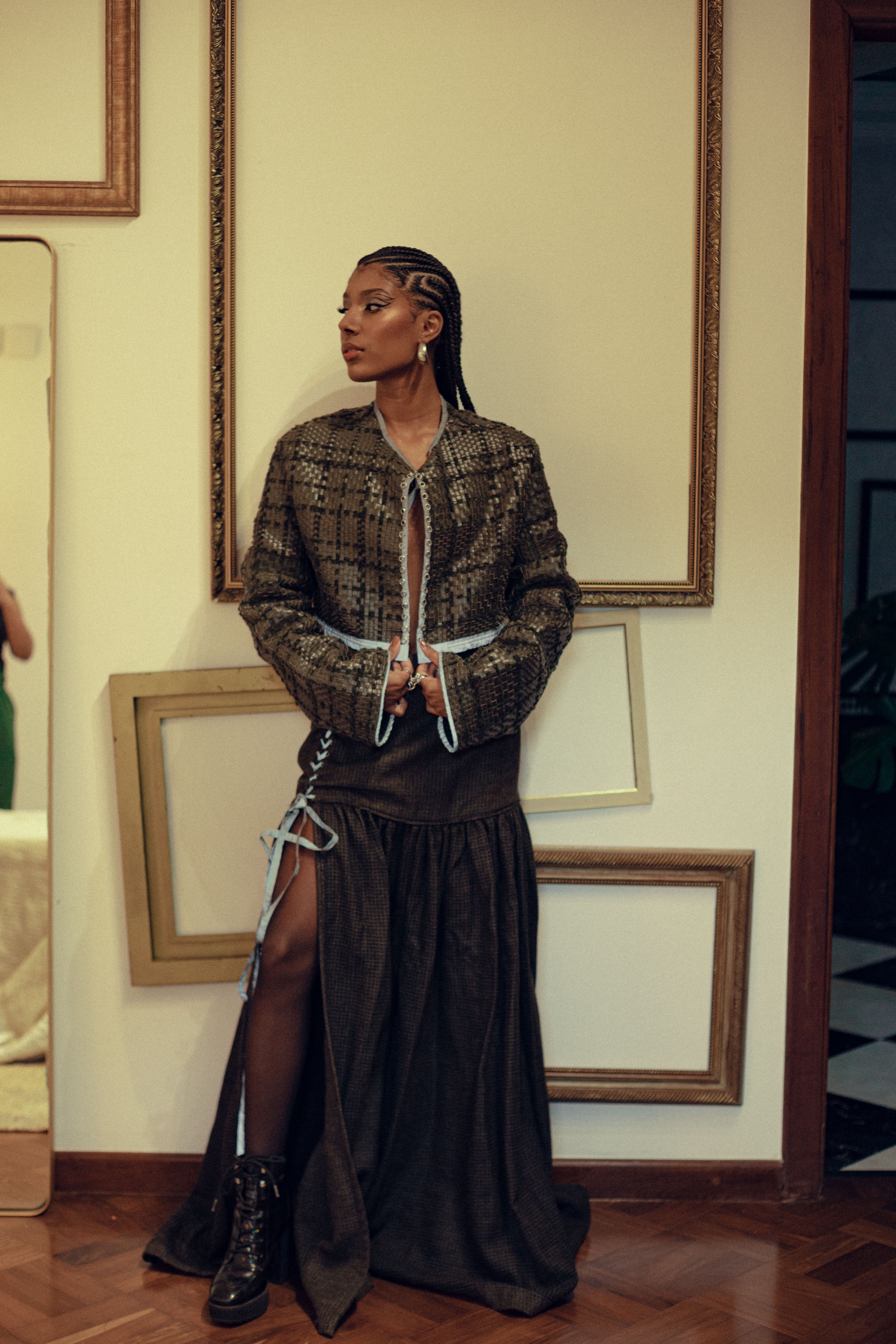 Contemporary portrait of a woman in stylish attire, standing indoors in São Paulo, Brazil.