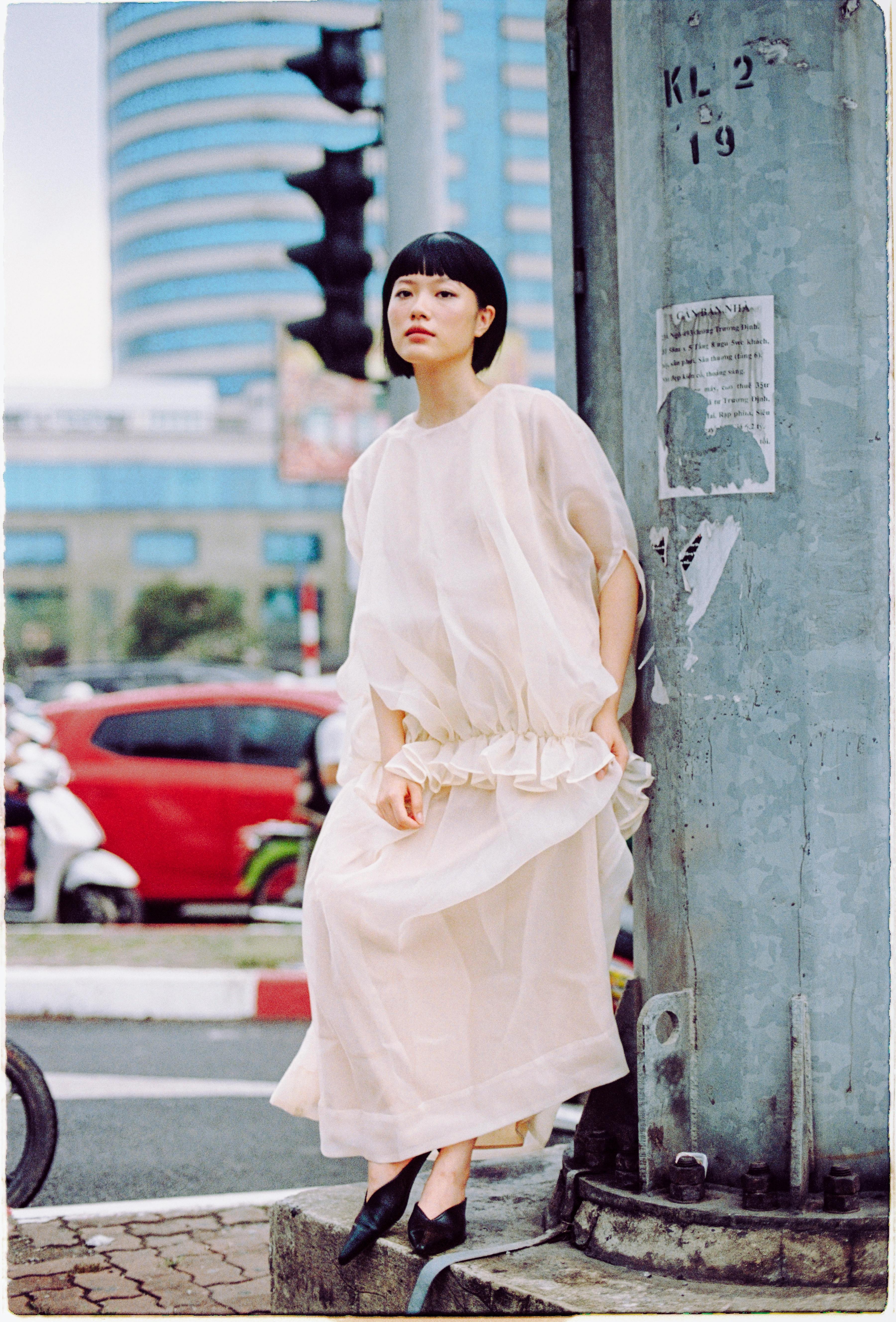 Chic urban fashion captured with a soft, modern vibe against a city backdrop.