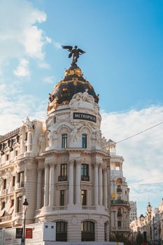 Stunning view of the iconic Metropolis Building in Madrid, showcasing exquisite architecture under a clear blue sky.