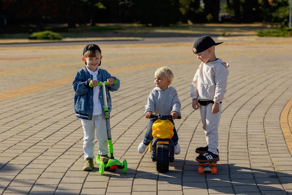 Kids Using Scooters Playful Kids on Scooters and Trike Outside · Free Stock Photo