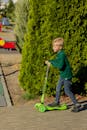 Young Boy Riding Scooter in Sunny Park