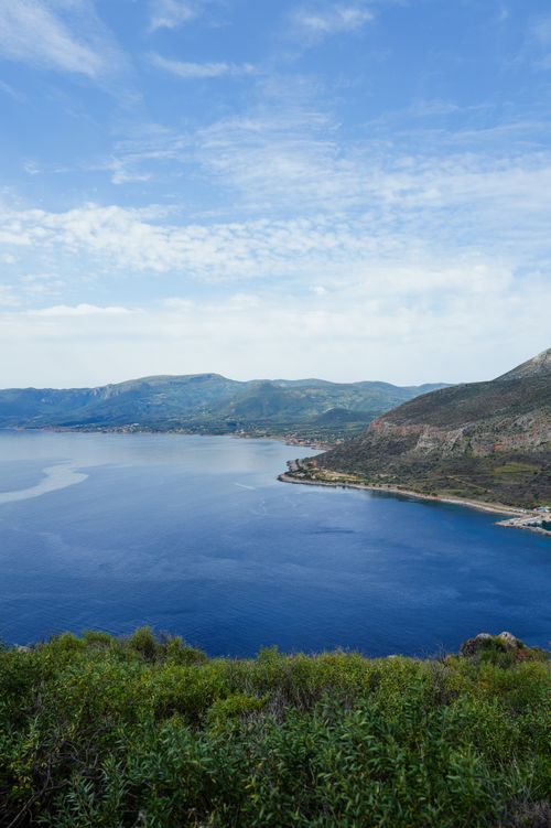 Free A breathtaking view of the Mediterranean coast with clear blue skies and lush greenery. Stock Photo