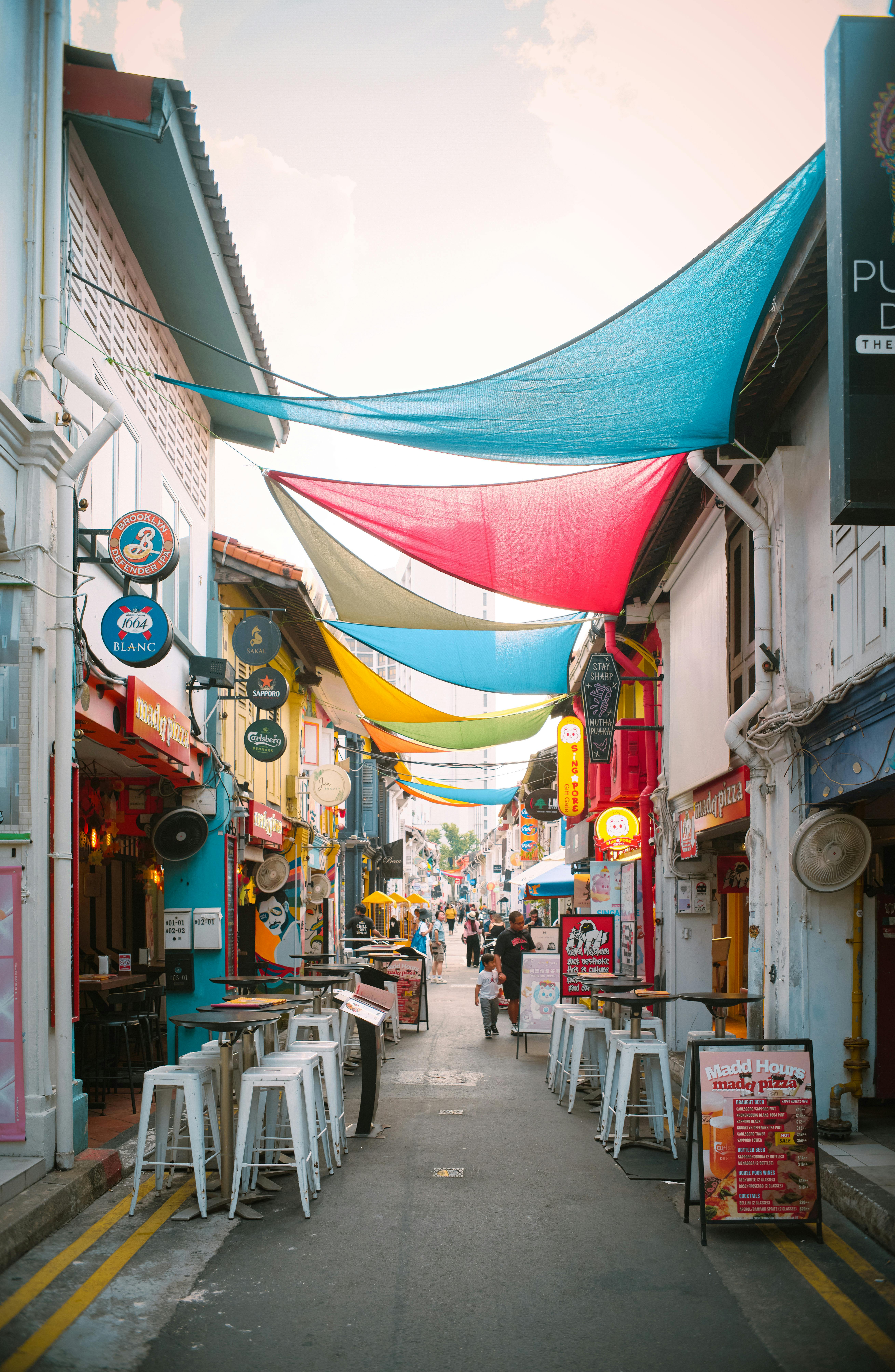 Lively street with colorful canopies and bustling shops, ideal for cultural exploration and travel inspiration.