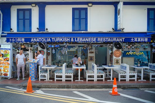 Outdoor view of Anatolia Turkish & Lebanese Restaurant with people around and vibrant décor.