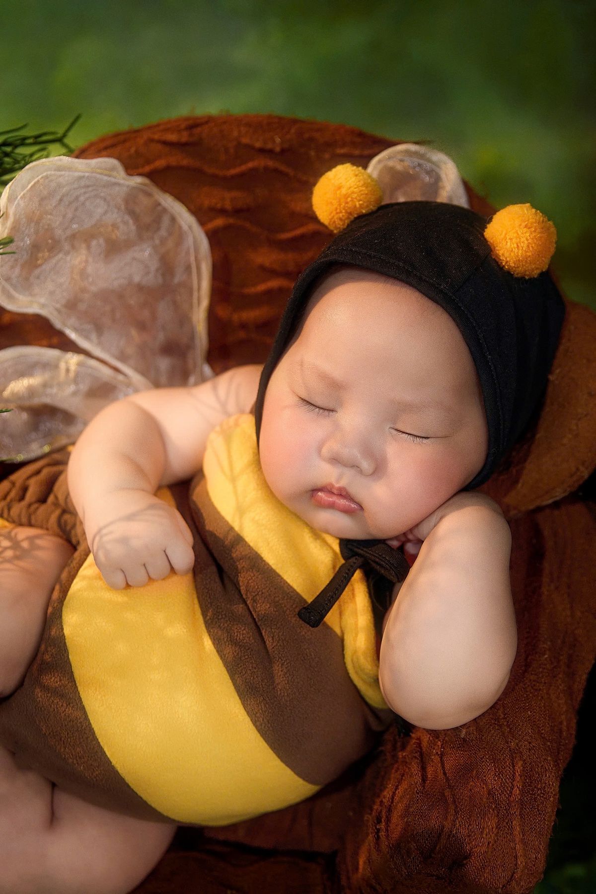 Toddler in a yellow and black bee costume with an antenna hat