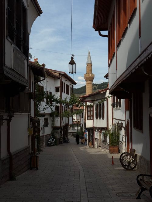 Free Historical alley with Ottoman architecture and distant minaret, serene ambiance. Stock Photo