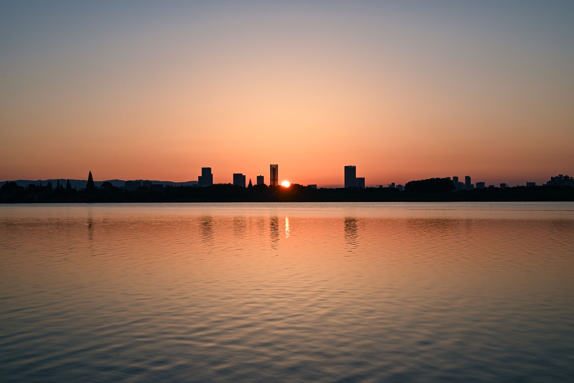 Late afternoon light over Uhuru Park lake with the Nairobi skyline behind