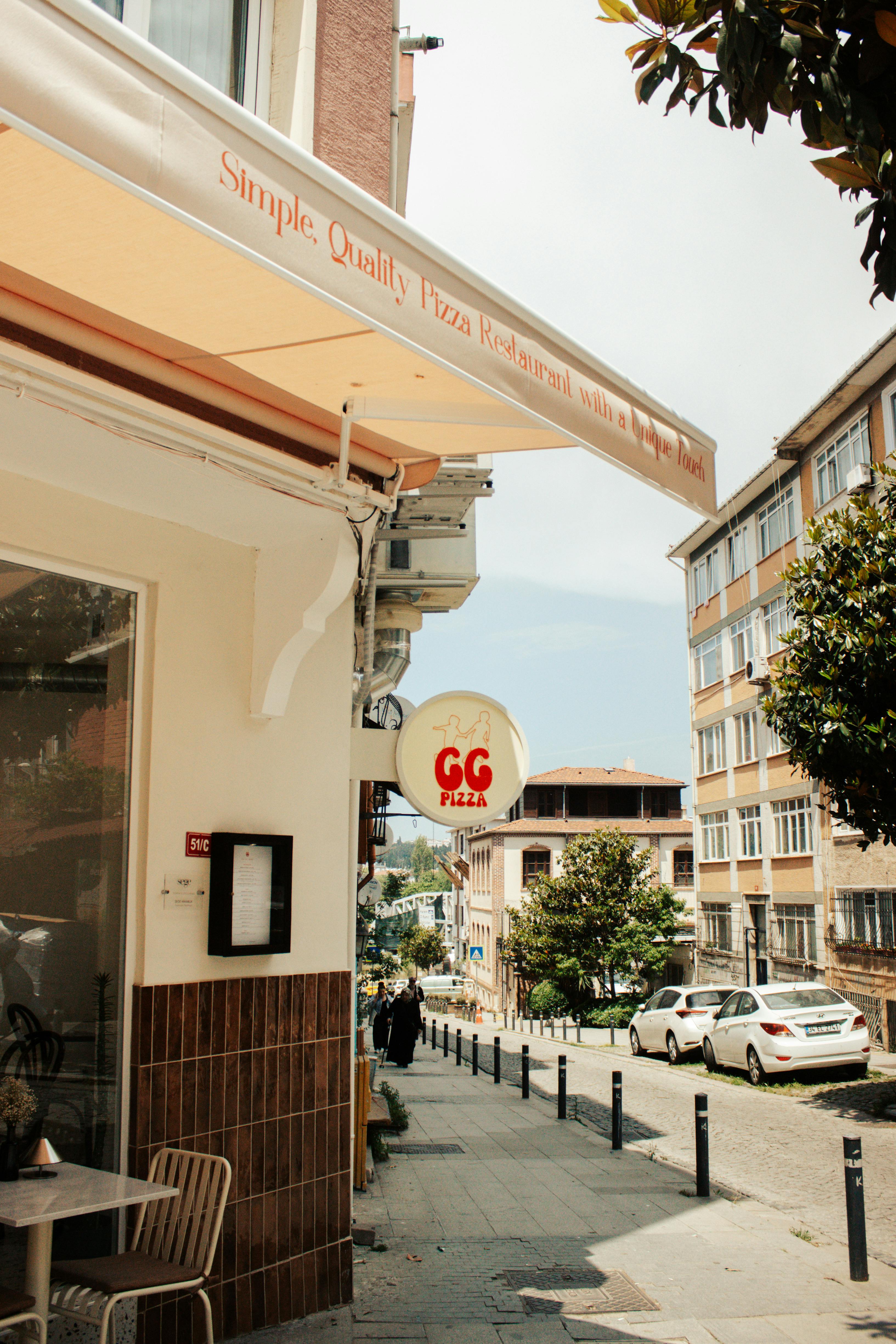 Charming street view featuring GG Pizza restaurant with urban architecture.