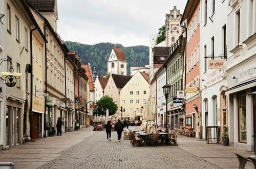 Free Picturesque street in Füssen, Bavaria with colorful buildings and cobblestone path. Stock Photo