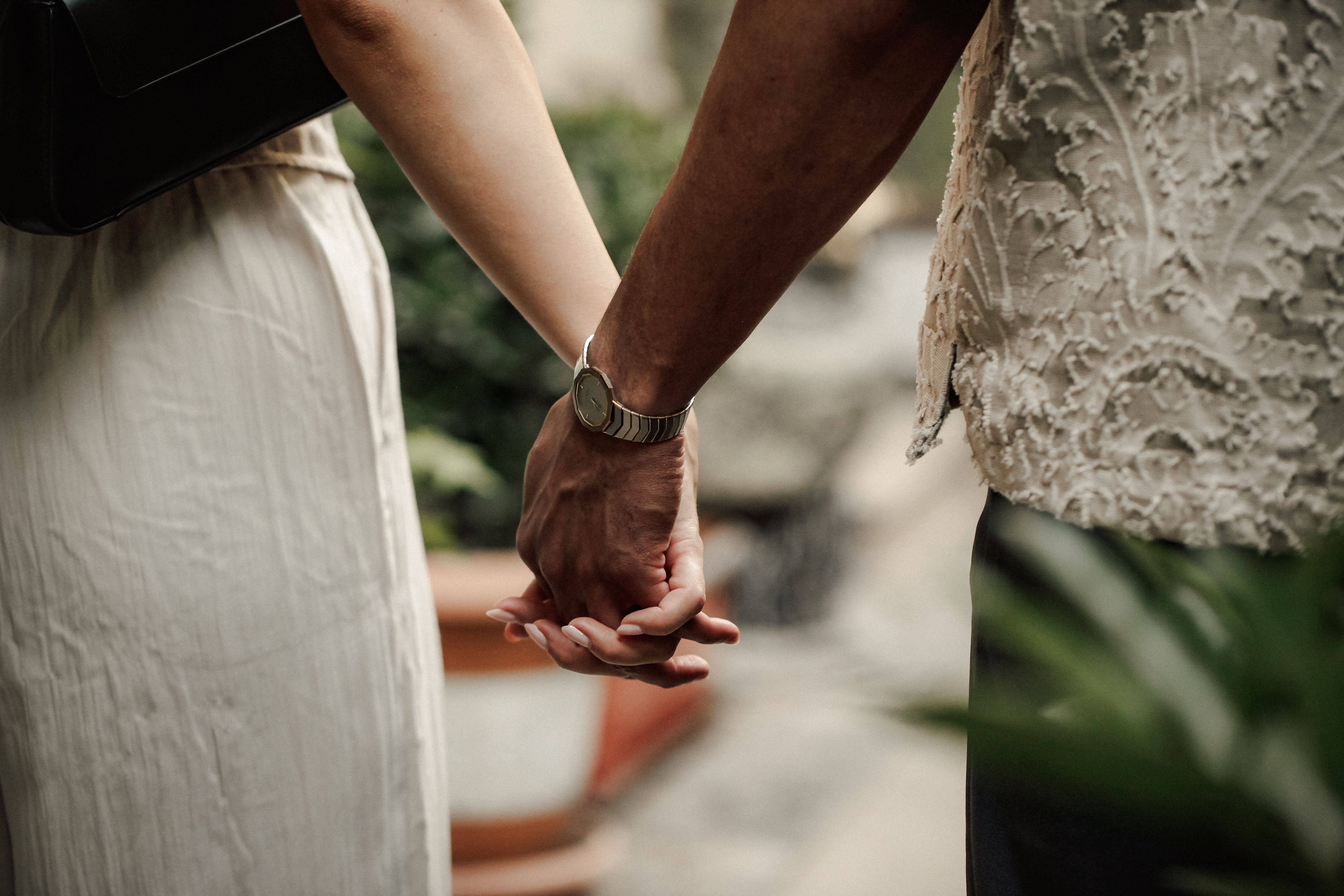 Close-up of a couple holding hands outdoors, symbolizing love and connection. Captured in Baku, Azerbaijan.