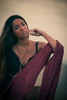 Stylish portrait of a woman outdoors with a decorative shawl, exuding elegance and confidence.