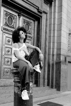 Chic young woman sitting confidently in a vibrant Buenos Aires street setting.