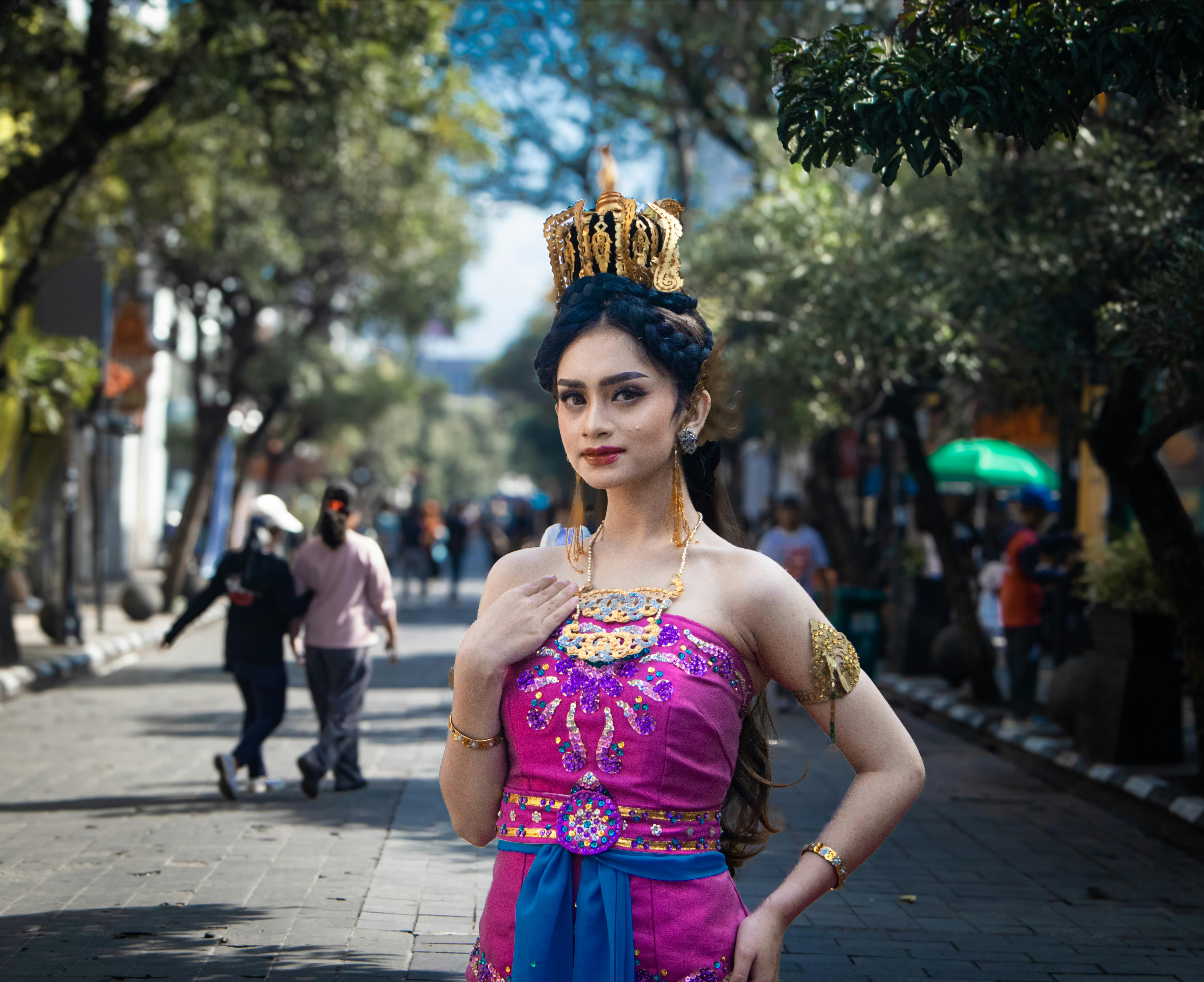 Elegant Indonesian woman in traditional attire on Braga Street, Bandung, West Java.