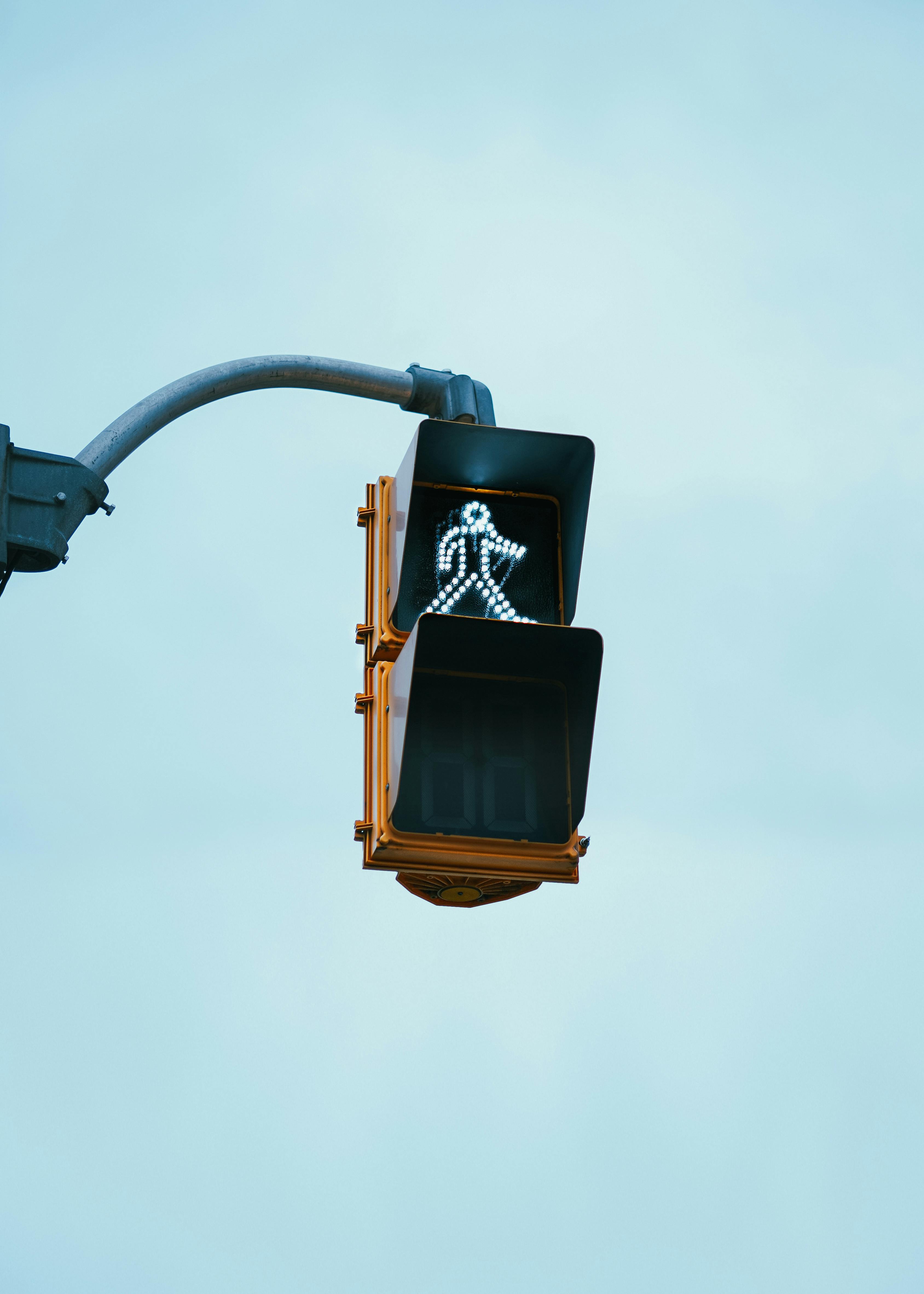 Free Pedestrian crossing signal indicating walk on a clear day in Kitchener, Ontario. Stock Photo