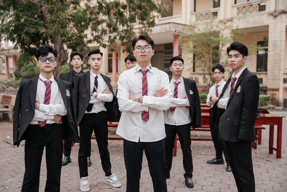 Young men in suits and ties posing confidently outdoors, showcasing elegance and unity. Young men in suits and ties posing confidently outdoors, showcasing elegance and unity.