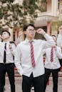 Students in Uniform Celebrating Outdoors