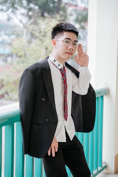 Free Confident young man in suit posing outdoors on a balcony setting. Stock Photo