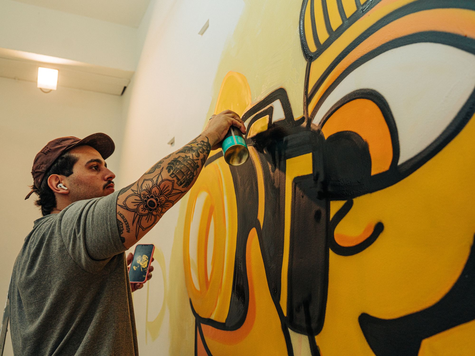 Painters & Decorators in Chadwell Heath, London — professional decorator painting a wall with a roller