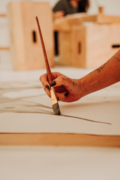 Free Close-up of a hand painting abstract art on canvas with a brush in an artistic studio. Stock Photo