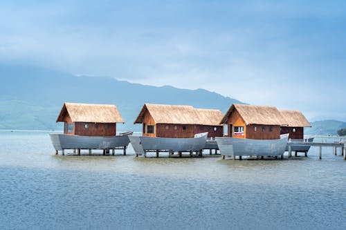 Brown Wooden Houses at Middle of Sea
