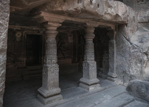 Explore the ancient architectural marvels of the Ellora Caves featuring intricate stone carvings.