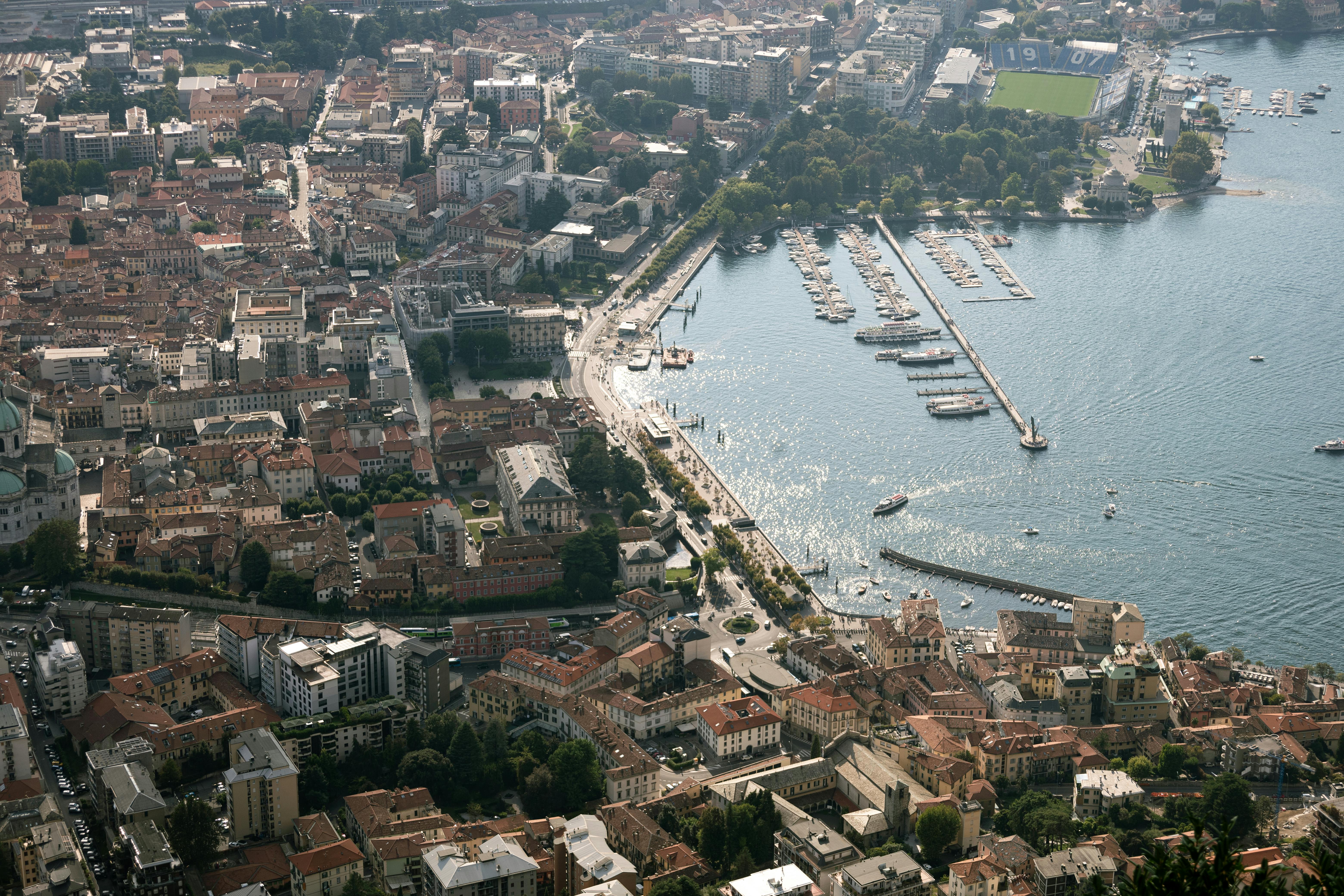 Aerial view of Lake Como in Lombardy, Italy, highlighting beautiful Italian architecture and marina.
