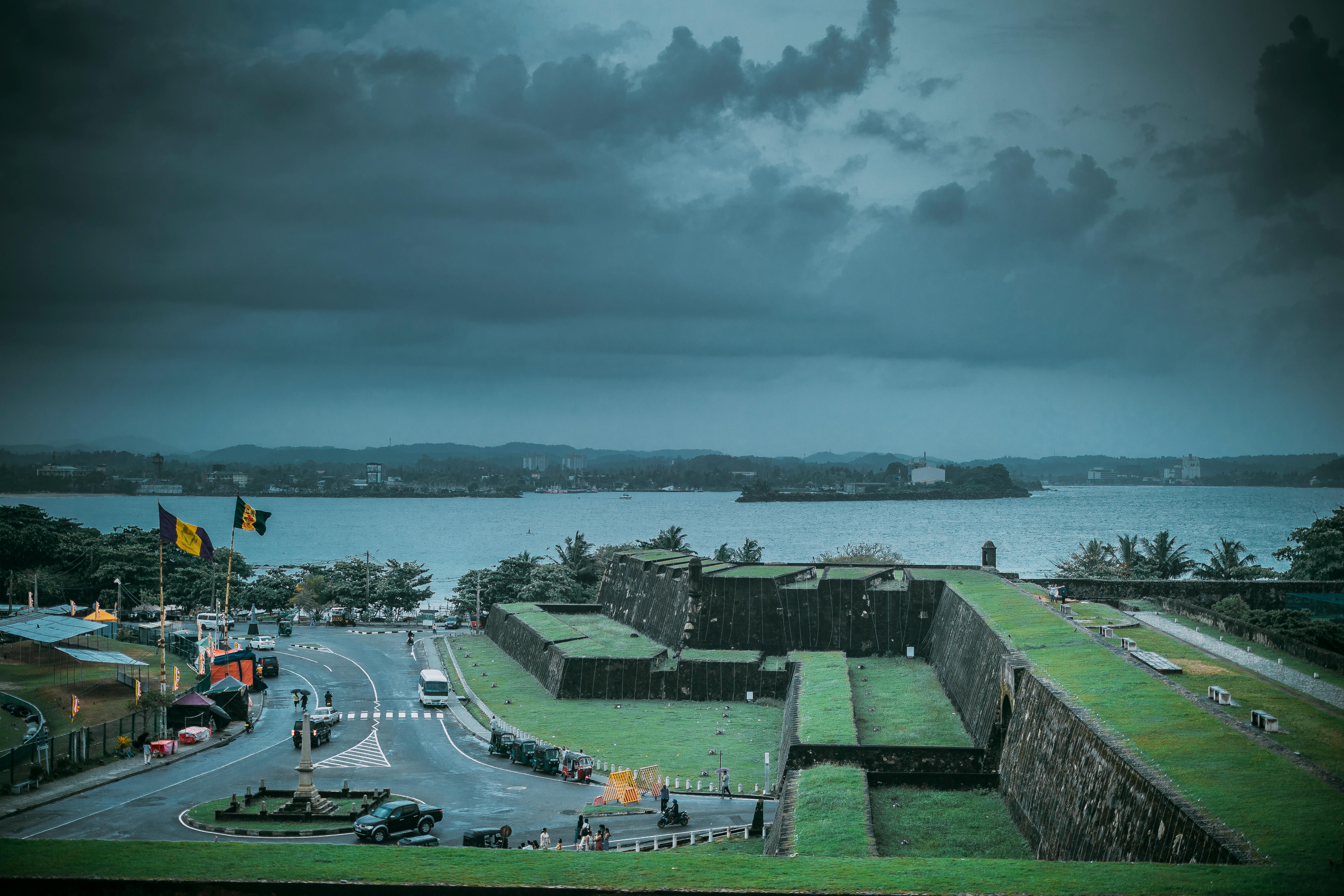 Breathtaking view of historic Galle Fort with the ocean backdrop under a dramatic sky.