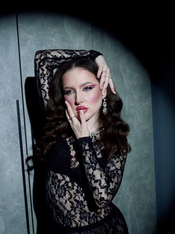 Elegant Woman in Black Lace Dress Striking a Pose · Free Stock Photo