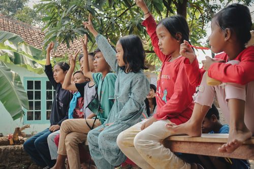 Free Children participating in a fun quiz in a village setting in West Java, Indonesia. Stock Photo