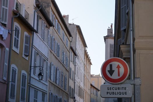 Scenic view of historic buildings and public sign in Marseille, France, capturing urban European architecture.
