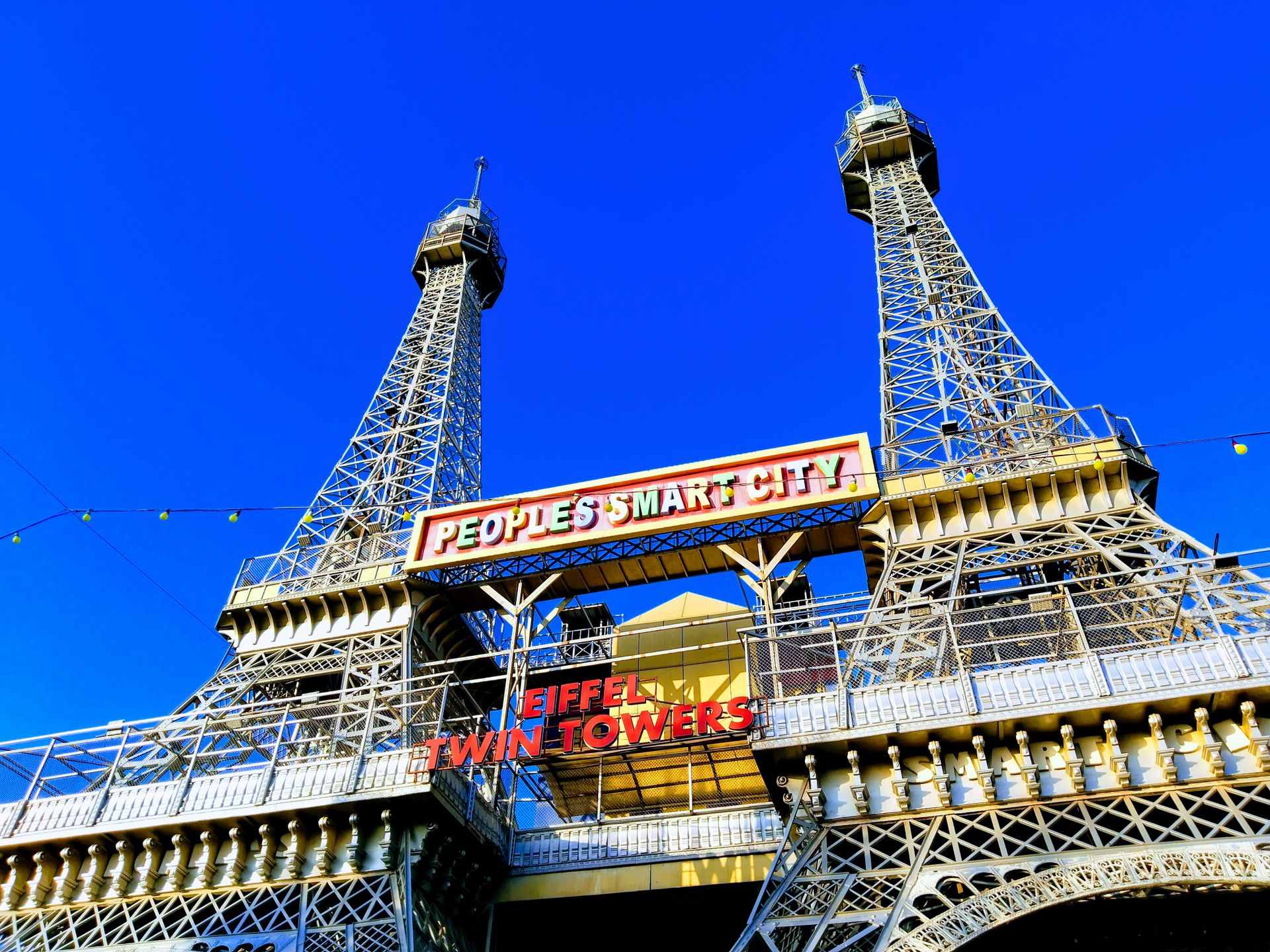 A modern replica of Eiffel Towers in Bhopal's People's Smart City under a clear blue sky.