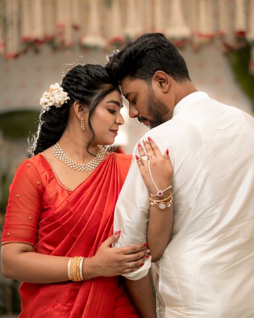 Free A couple in traditional Indian clothing shares a tender moment indoors, highlighting cultural elegance. Stock Photo