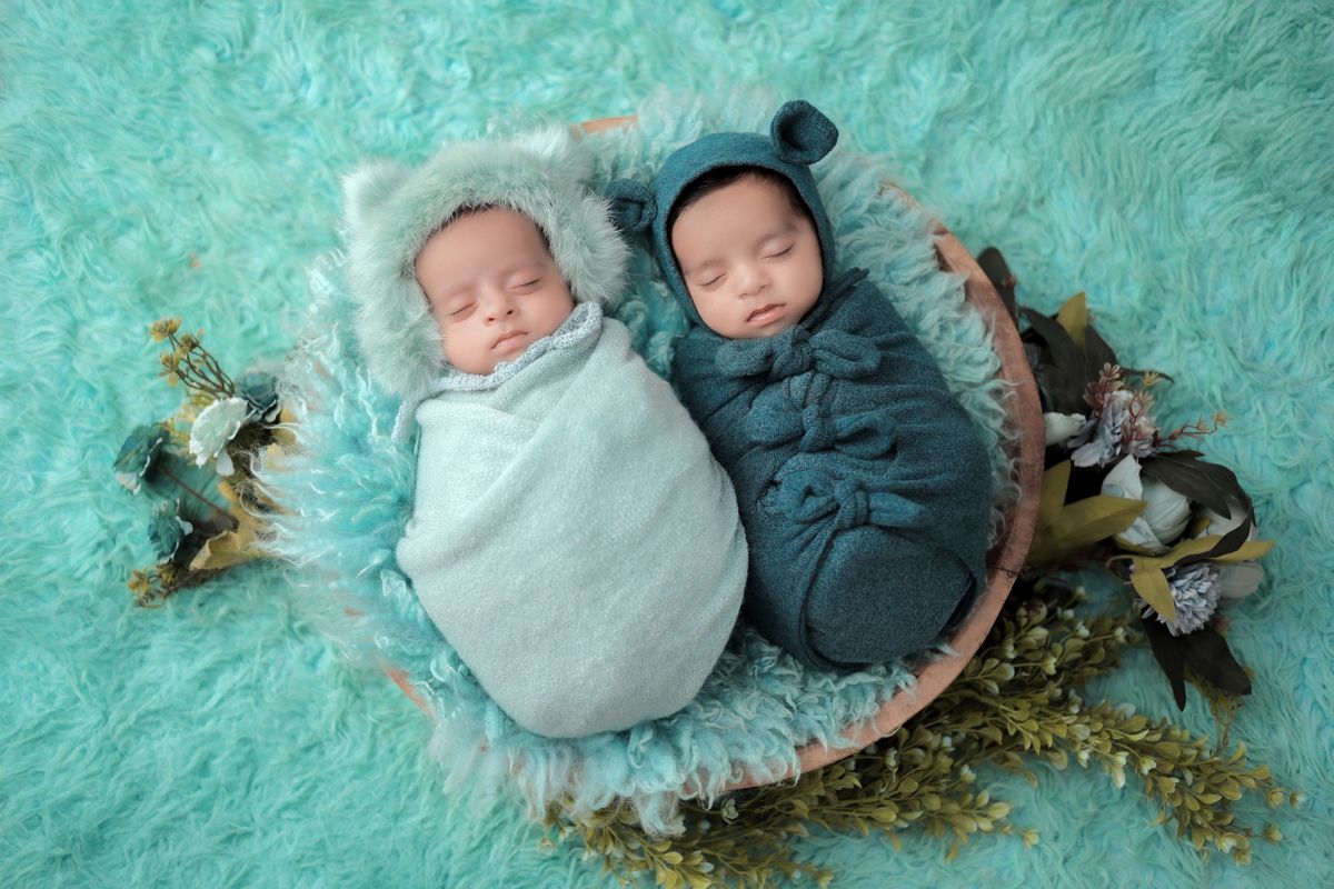 Baby sleeping in a soft organic cotton sleep sack in a crib