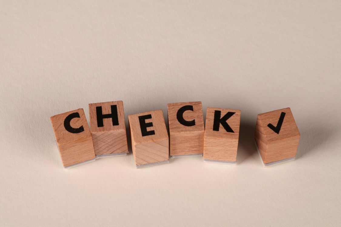 Check Block Letters Wooden Blocks Spelling 'Check' with Checkmark · Free Stock Photo