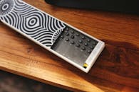 Aesthetic Remote Control on Wooden Surface