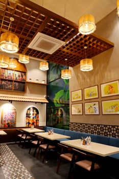 Warm and inviting restaurant interior with artistic decor and ambient lighting for a cozy dining experience.