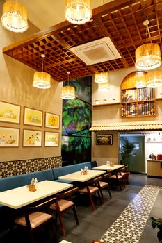 Inviting cafe interior featuring modern design and artistic decor with warm lighting.