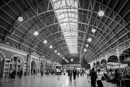 Free Striking black and white photo capturing the grand architecture of Sydney Central Station with bustling travelers. Stock Photo