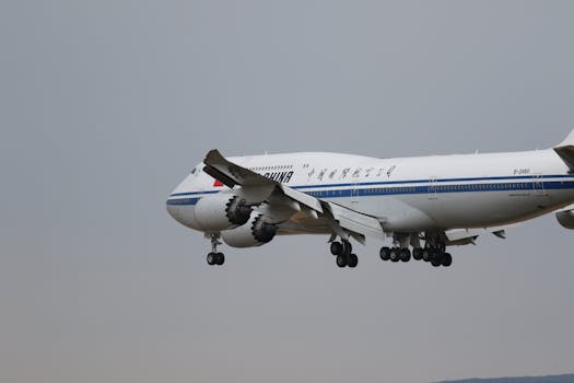 A commercial airliner with Chinese markings approaches Frankfurt Airport during the day.