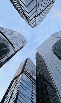 Towering skyscrapers in Jakarta's central business district against a clear blue sky.