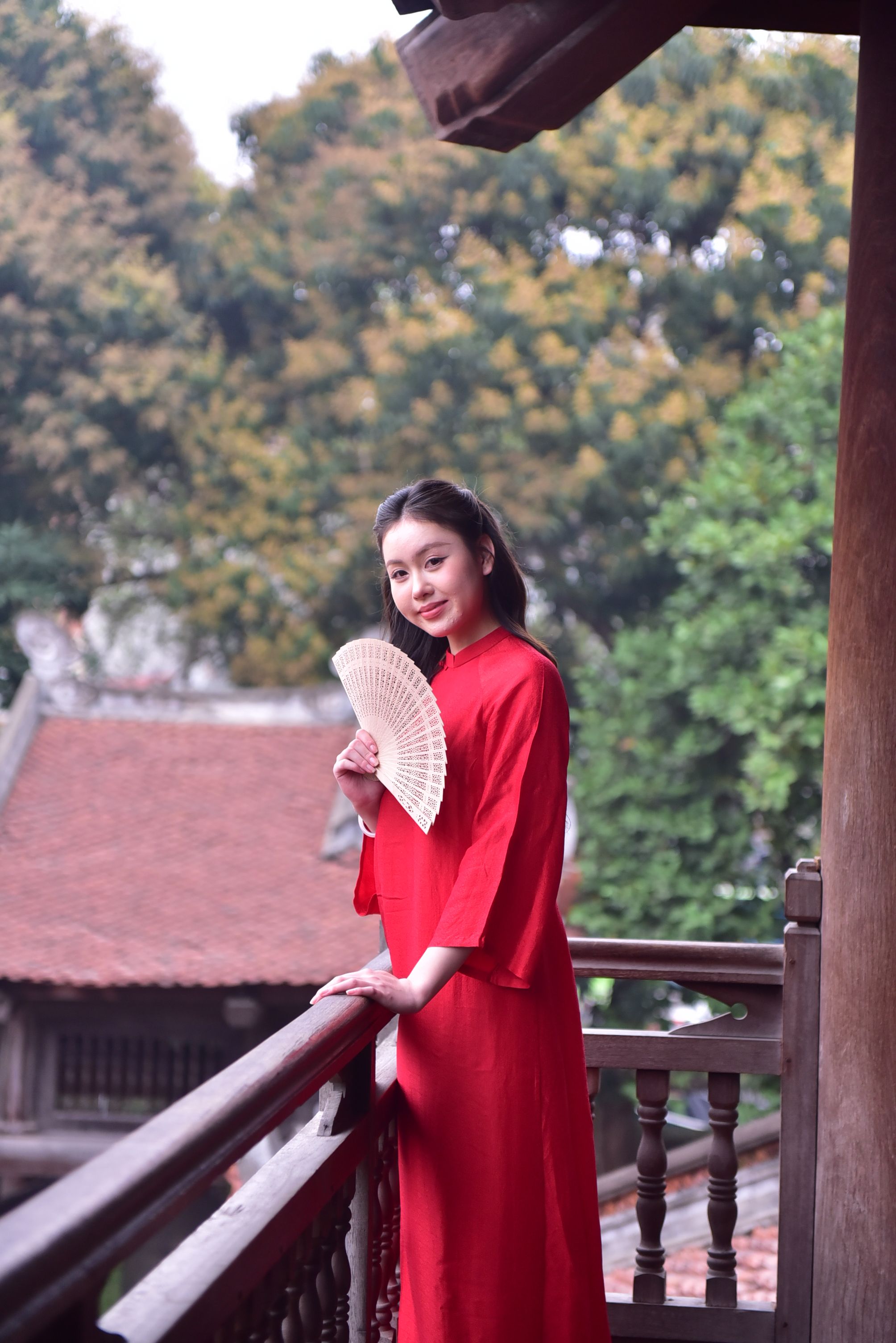 Woman in Traditional Red Dress with Fan Outdoors · Free Stock Photo