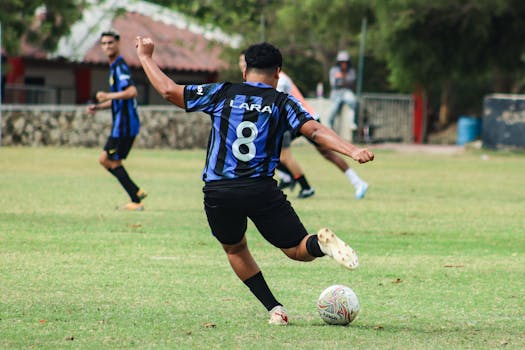 A thrilling moment in an amateur soccer match in a Colombian park, capturing the action and passion of the game.
