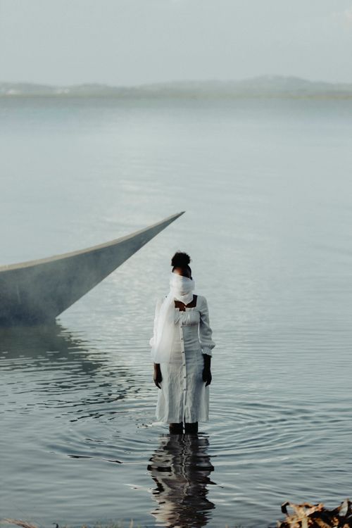 Calm Figure Solitary Figure in Tranquil Waters at Dusk · Free Stock Photo