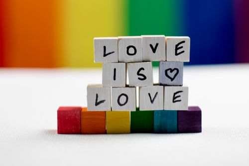 Free Wooden blocks displaying 'Love is Love' with rainbow colors, symbolizing diversity and pride. Stock Photo
