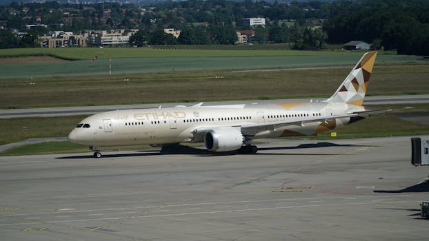 Etihad Airways Boeing 787 Dreamliner on a runway during a sunny day at an airport.