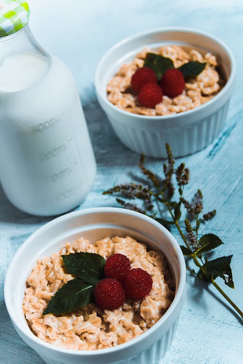 Oatmeal on Bowls Topped with Raspberries