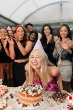 A cheerful birthday party scene with friends celebrating with cake and laughter indoors.