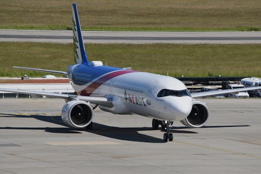 A commercial jet taxiing on the runway at Genève Airport, Switzerland, under sunny skies.