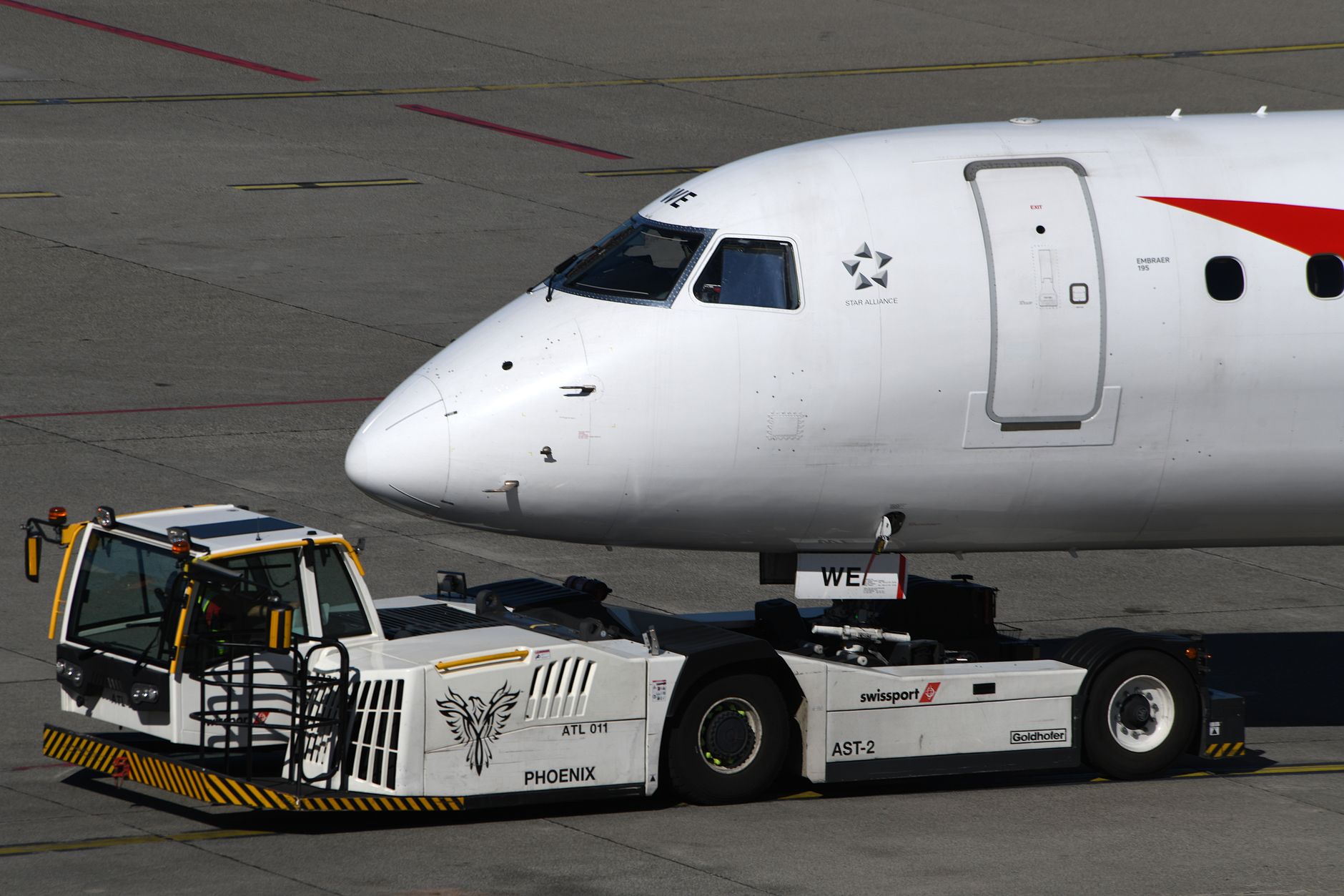 Close-up of a commercial aircraft being towed at Geneva Airport, Switzerland.